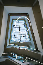 Three Ringo Star LED pendant lights from Lightnet illuminate the modern stairwell in Delbrück Town Hall